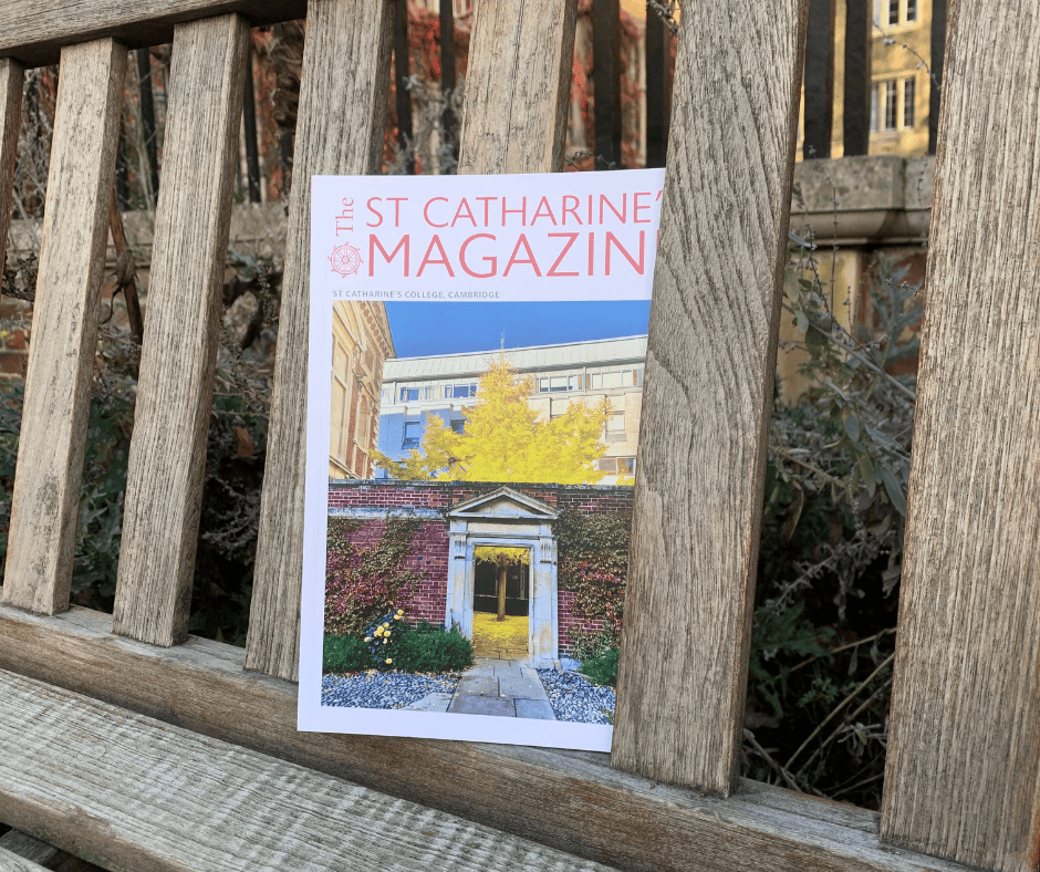 Magazine being held up in a garden setting